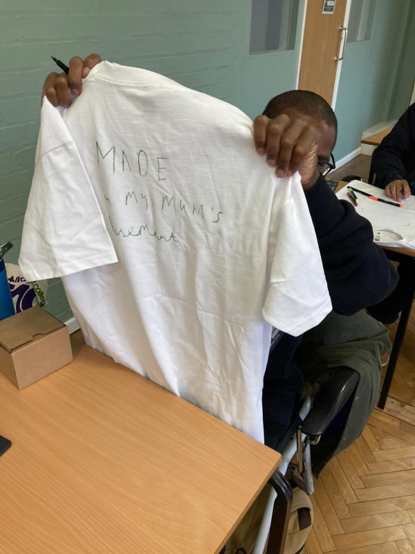 Student holding up t-shirt
