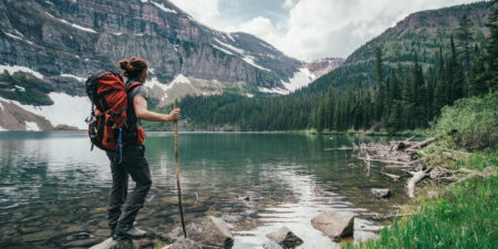 person standing near lake