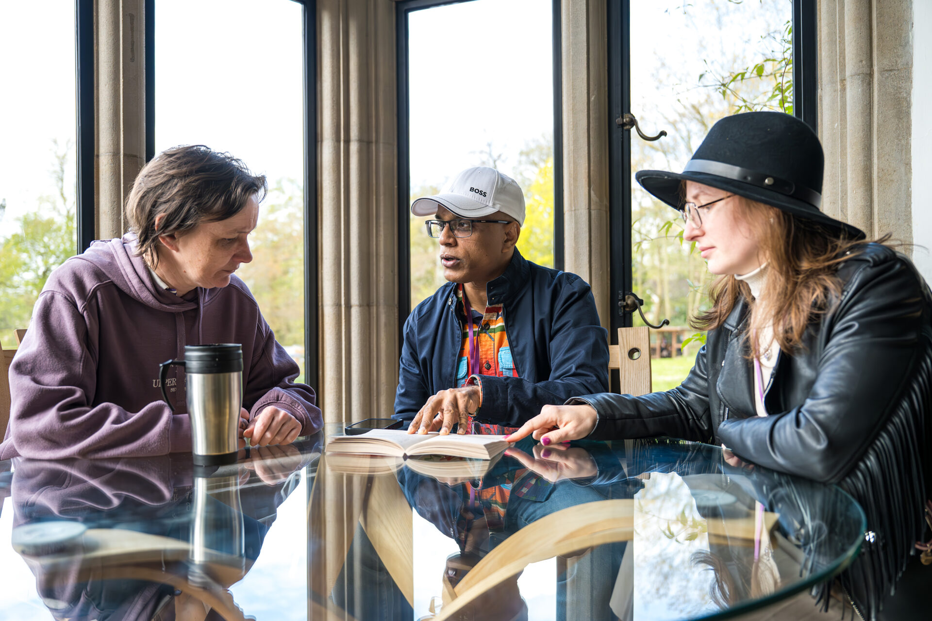2 female and 1 male student seated at a table